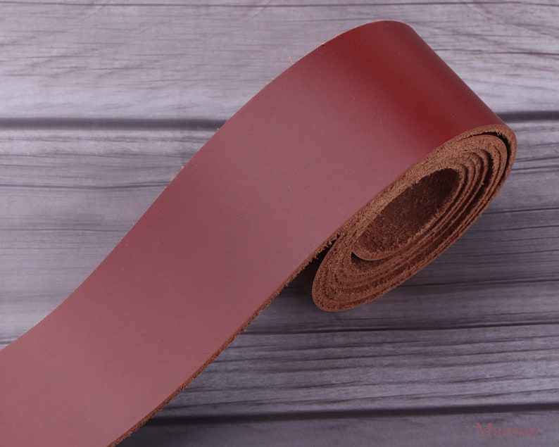 May include: A roll of dark red leather strap, perfect for crafting projects. The leather is smooth and supple, with a natural grain.