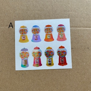 May include: A sheet of stickers featuring eight colorful gumball machine illustrations. Each machine has a clear globe filled with multi-colored gumballs. The machines are in various colors, including yellow, purple, orange, and pink.