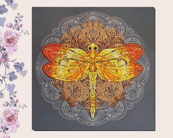 May include: A square wall art piece featuring a vibrant yellow and orange beaded dragonfly centered over a dark gray background with a white circular mandala line drawing. The dragonfly is detailed with intricate textures and small beads.