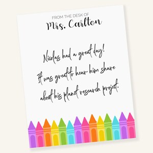 May include: A white note with black text that reads "FROM THE DESK OF Mrs. Carlton Nicolas had a great day! It was great to hear him share about his planet research project." The note is decorated with a row of colorful crayons at the bottom.