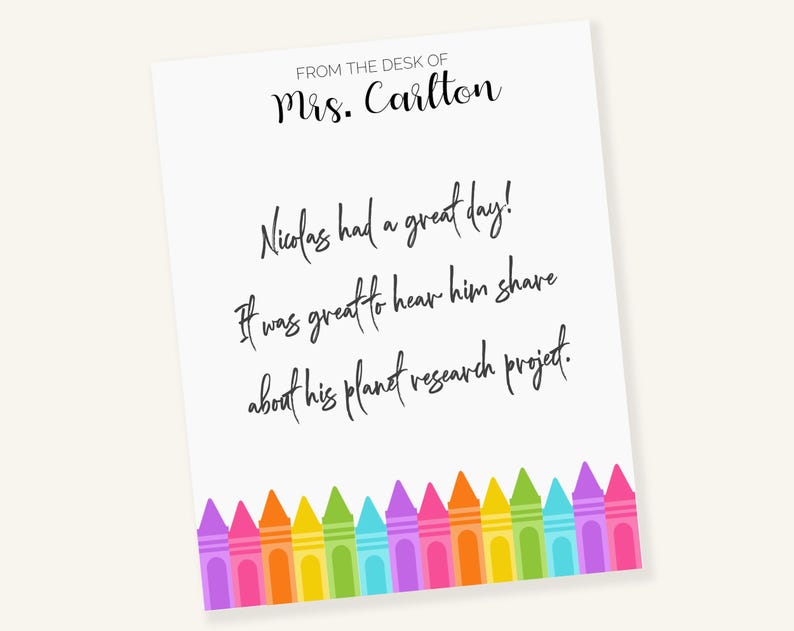 May include: A white note with black text that reads "FROM THE DESK OF Mrs. Carlton Nicolas had a great day! It was great to hear him share about his planet research project." The note is decorated with a row of colorful crayons at the bottom.
