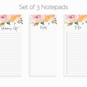 May include: Set of three floral notepad sets with pink and yellow watercolor flowers. The notepads are labeled "Shopping List", "Notes", and "To Do".