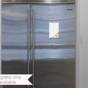 May include: A white magnetic notepad with a floral design and the text "To Do List" on a stainless steel refrigerator.