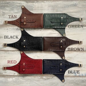 May include: Five leather belts with different coloured crocodile embossed patterns. The belts are labelled "TAN", "GREEN", "BLACK", "BROWN", and "BLUE".