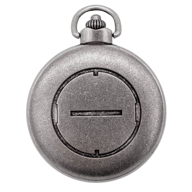 May include: A silver pocket watch with a circular face and a single line across the center. The watch has a decorative knob on the top.