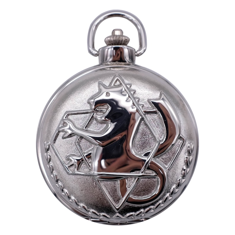 May include: Silver pocket watch with a detailed engraving of a mythical creature, possibly a griffin, inside a geometric design.