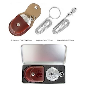May include: A silver pocket watch with a chain and a brown leather case. The watch is in a silver tin with a black foam interior. The case is 70 x 80 mm. The chain is 300 mm long.