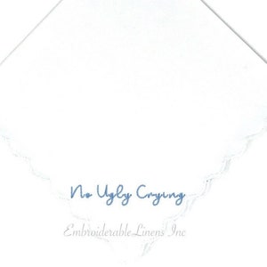 May include: White cotton handkerchief with a scalloped edge hem. The handkerchief is embroidered with the text "No Ugly Crying" and "Embroiderable Linens Inc."