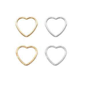 May include: Four heart-shaped hoops, two gold and two silver. The hoops are open and have a hammered texture.