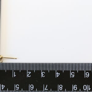 May include: A gold-toned earring finding with a small ball at the top and a straight post.