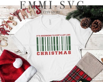 May include: White t-shirt with the text "It's Beginning to Cost a Lot Like Christmas" in green and red. A red Santa hat, a Christmas stocking, and decorative elements are also visible. The design is for instant download digital files.