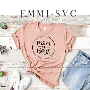 May include: A digital download of a black and white graphic design featuring a circle with the text "From Son Up Mom of Boys Till Son Down".