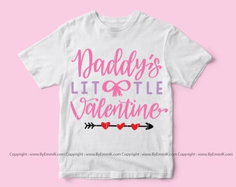 May include: White t-shirt with pink text that reads "Daddy's Little Valentine" with a pink bow and red hearts and an arrow.