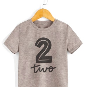 May include: Gray short-sleeved t-shirt with a black number "2" and the word "two" printed on the front.