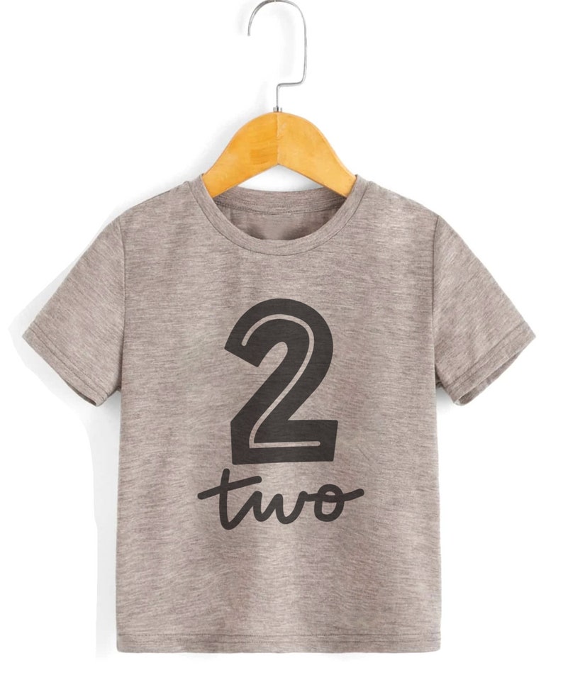 May include: Gray short-sleeved t-shirt with a black number "2" and the word "two" printed on the front.