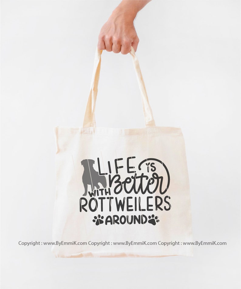 May include: A white canvas tote bag with a black silhouette of a Rottweiler and the text "Life is better with Rottweilers around".