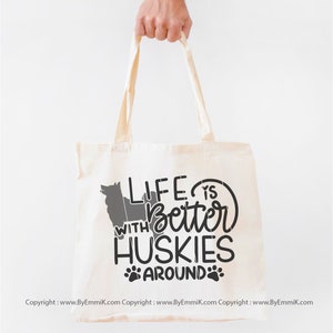 May include: A white canvas tote bag with black text that reads "Life is better with Huskies around" and a paw print graphic.
