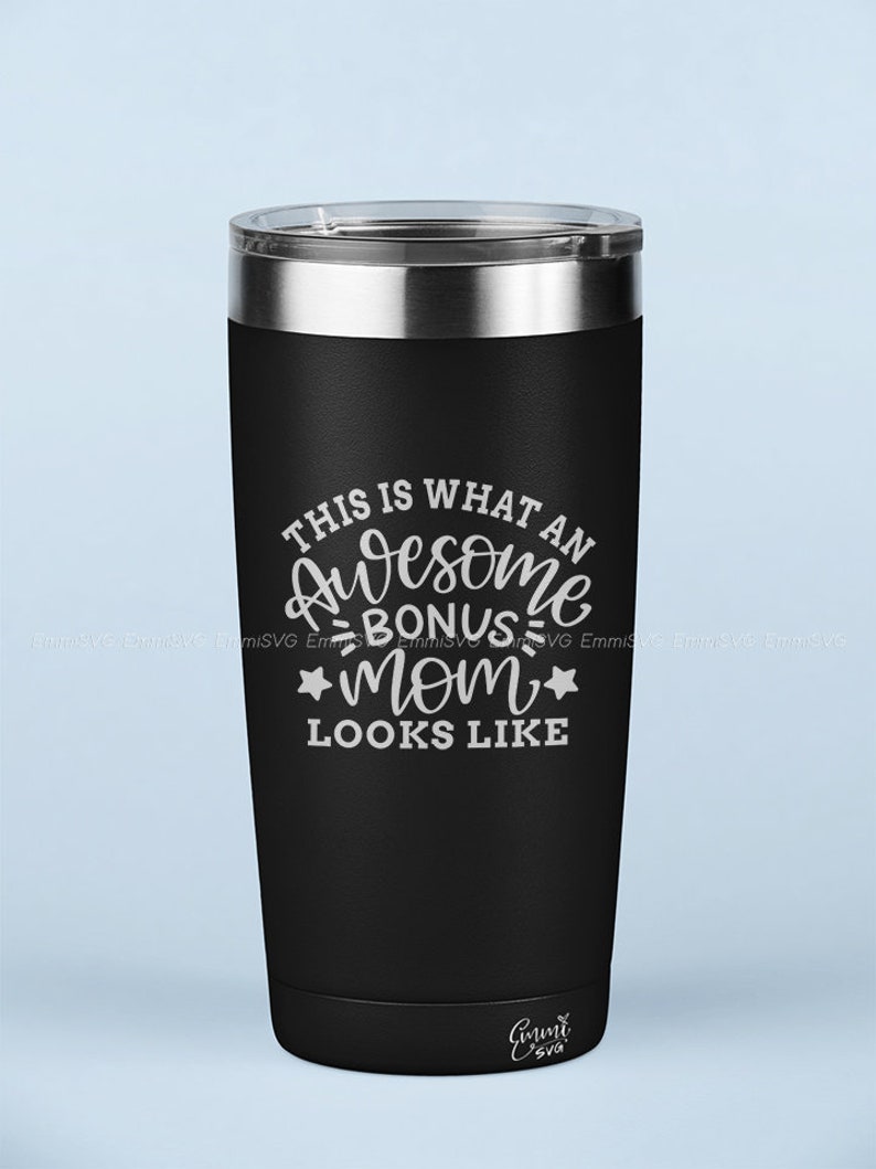 May include: Black stainless steel tumbler with a white inscription that reads "This is what an awesome bonus mom looks like".