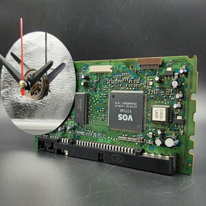 May include: A green circuit board with black components and text that reads "VOS V71100 01232D TAIWAN 22400311".
