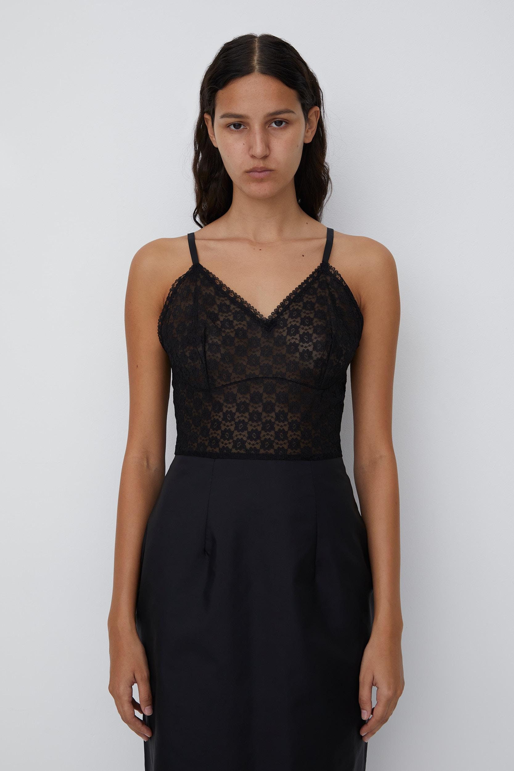 Vintage delicate chemise made from sheer lace and nylon with scallop neckline
