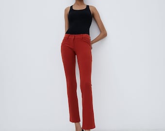 Vintage Norma Kamali Red orange low rise stretch pants that sit straight through the leg