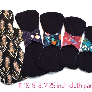 May include: Five reusable cloth pads in various sizes, ranging from 7.25 inches to 11 inches. The pads are black with colorful floral patterns and have snap closures.