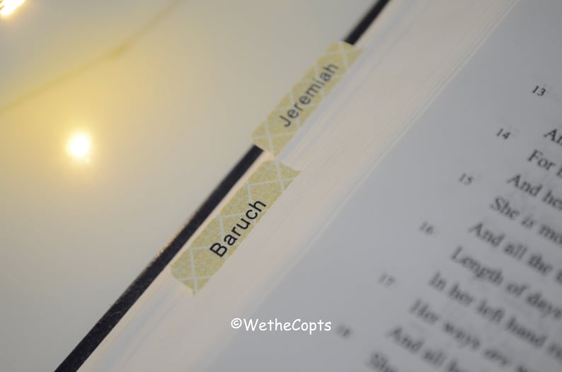 May include: Close-up of a book with two yellow sticky notes. The top note says "Jeremiah" and the bottom note says "Baruch".