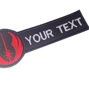 Op de afbeelding: Zwarte en rode geborduurde patch met het Rebel Alliance-symbool en een wit tekstlabel met de tekst "YOUR TEXT".