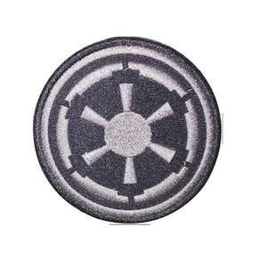May include: An embroidered patch featuring the Star Wars Galactic Empire logo in black and white.