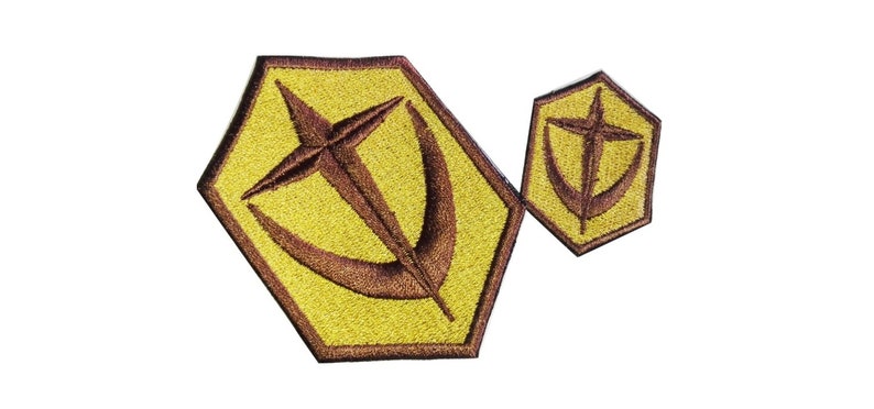 May include: Two embroidered patches in a hexagonal shape with a brown star and crescent moon design on a yellow background.