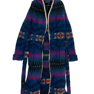 May include: A long, blue robe with a white trim and a colourful geometric pattern. The robe has a tie belt and a shawl collar.