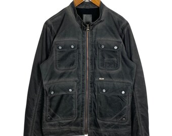 May include: A black zip-up jacket with multiple pockets and a stand-up collar.