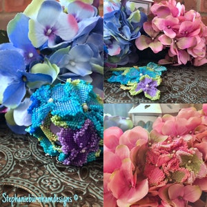 May include: A close-up of three beaded flower brooches. The brooches are made with blue, green, purple, and pink beads. The brooches are surrounded by hydrangea flowers.