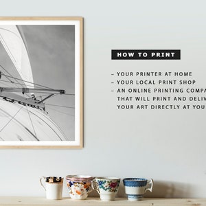 May include: A black and white photograph of a sailboat's rigging against a cloudy sky. The image is framed in a light wood frame. The text "HOW TO PRINT" is written in black text on a white background. The text below "HOW TO PRINT" lists different ways to print the image, including using a home printer, a local print shop, or an online printing company.