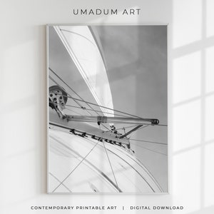 May include: Black and white photograph of a sailboat's rigging, showing the ropes and pulleys used to control the sails.