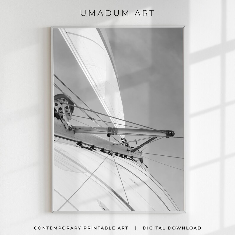 May include: Black and white photograph of a sailboat's rigging, showing the ropes and pulleys used to control the sails.