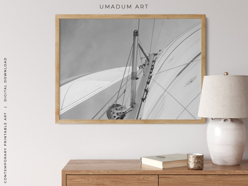May include: A black and white photograph of a sailboat's mast and rigging. The image is taken from the deck of the boat, looking up at the mast.