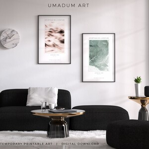 May include: Two abstract art prints with black frames, one with a pink and white design and the other with a green and white design. The prints are hanging on a white wall above a black sofa and a coffee table with a glass top. The text on the prints reads "Esthetique de l'aventure" and "Un air de liberte".