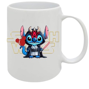 May include: White ceramic mug featuring a cartoon character in a black hooded robe, holding a red lightsaber and a red heart-shaped balloon. The mug has the words "Star Wars" in gold lettering.