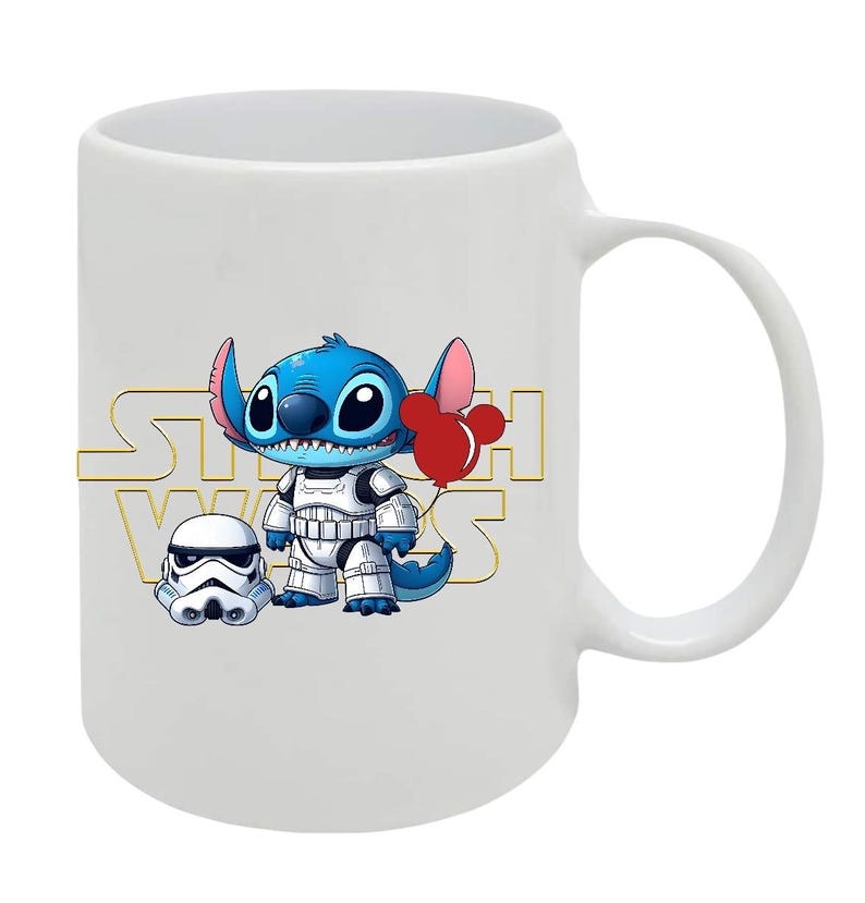 May include: White ceramic mug featuring a blue cartoon character with large eyes, wearing a white stormtrooper outfit and holding a red balloon. The mug has the words "STAR WARS" in gold lettering.