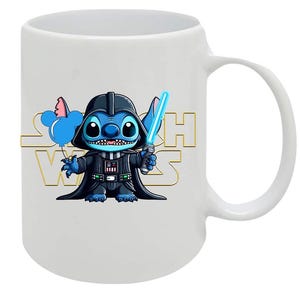 May include: White ceramic mug featuring a cartoon Stitch character dressed as Darth Vader, holding a blue lightsaber and a Mickey Mouse balloon. The words "Star Wars" are in gold lettering on the mug.