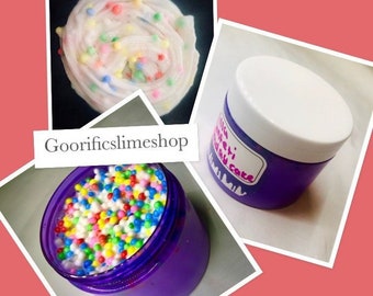 May include: A purple jar filled with white slime with colorful sprinkles. The jar has a white lid and a label that says "Confetti Birthday Cake".