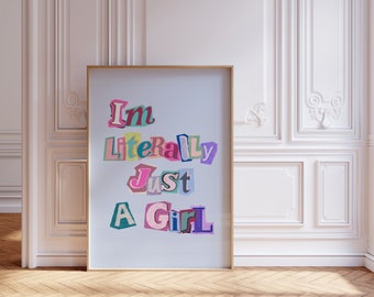 May include: A framed print with the text "I'm Literally Just A Girl" in colorful, cut-out letters on a light blue background.