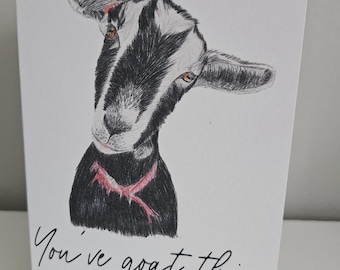 May include: A white greeting card with a pencil drawing of a goat. The goat has black and white markings, brown eyes, and a red collar. The card includes the cursive text "You've goat this" below the illustration.