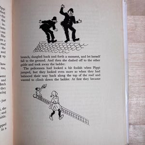 May include: A page from a book featuring two black and white illustrations. The top shows two policemen on a roof. The bottom shows a girl carrying a ladder with a monkey holding a hat. The text describes Pippi jumping and the policemen on the roof.