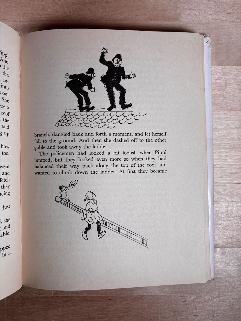 May include: A page from a book featuring two black and white illustrations. The top shows two policemen on a roof. The bottom shows a girl carrying a ladder with a monkey holding a hat. The text describes Pippi jumping and the policemen on the roof.
