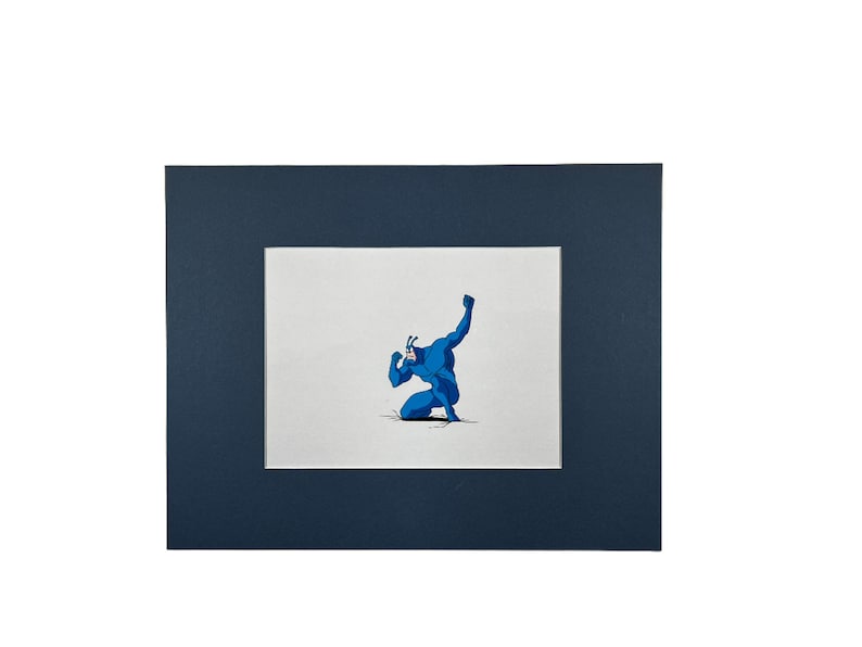 May include: A blue superhero character with a mask and a pointed head is kneeling with one arm raised in the air. The character is drawn in a cartoon style on a white background.