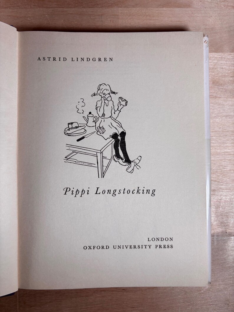 May include: The title page of the book Pippi Longstocking by Astrid Lindgren, published by Oxford University Press in London. It features a black ink line drawing of a character sitting on a table with a teapot, plate, and knife.