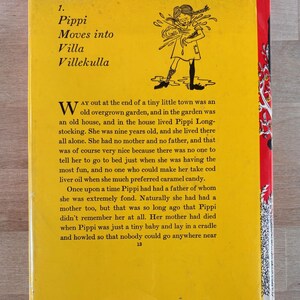 May include: A yellow book cover featuring a black and white illustration of a girl with braided hair. The text reads: From Pippi Longstocking, 1. Pippi Moves into Villa Villekulla, and includes a paragraph starting with Way out at the end of a tiny little town.