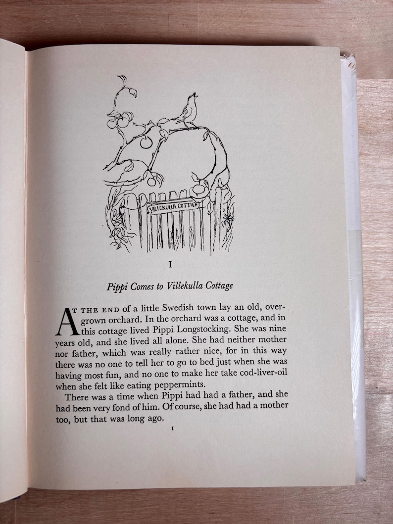 May include: A page from a book featuring a black and white line drawing of a bird perched on a gate labeled Villekulla Cottage. Below the illustration, the text reads: I, Pippi Comes to Villekulla Cottage, and the opening paragraph of the story.